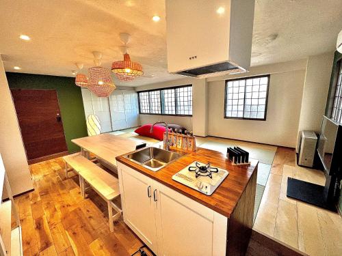 a kitchen with a sink and a counter top at Swiss Inn in Sapporo