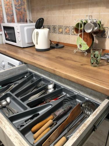 a kitchen stove with a drawer full of utensils at Vintage Apartment 2 rooms with Balcony in Lviv