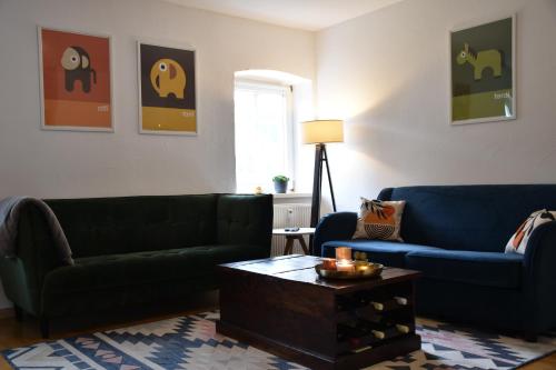 a living room with two couches and a coffee table at Ferienwohnung Happynest in Birresborn