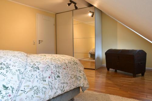 a bedroom with a bed with a dresser and a closet at Ferienwohnung Happynest in Birresborn