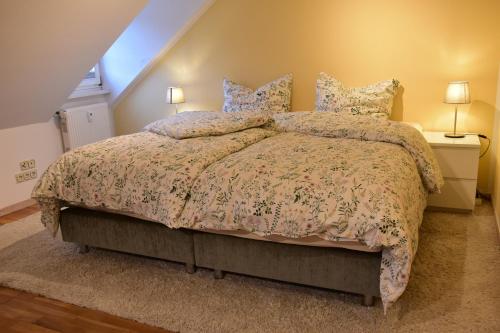 a bedroom with a large bed with a comforter and pillows at Ferienwohnung Happynest in Birresborn