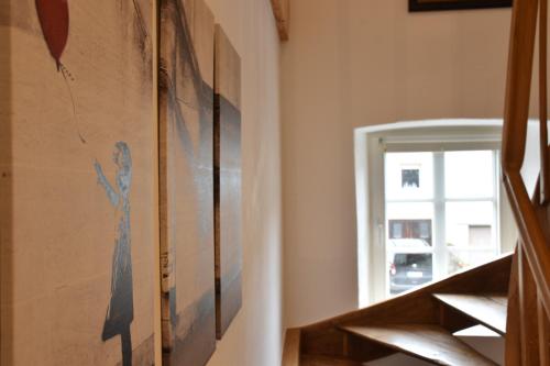 a hallway with stairs with a painting on the wall at Ferienwohnung Happynest in Birresborn