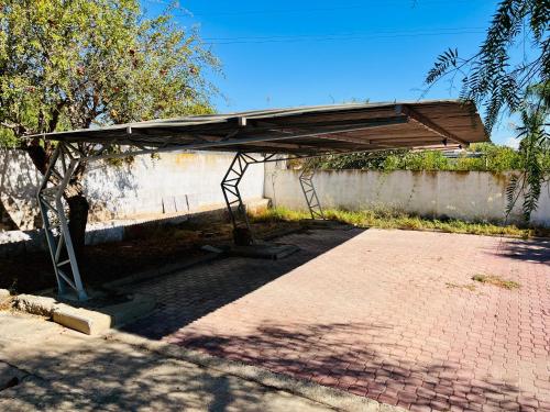 a wooden structure sitting on a brick sidewalk at Estudio adosado acogedor con jardín, barbacoa y parking privado in Alicante