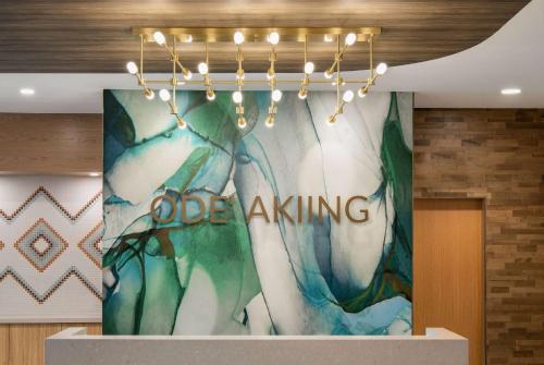 a chandelier with the word office killing on a wall at Wyndham Garden Winnipeg Airport in Winnipeg