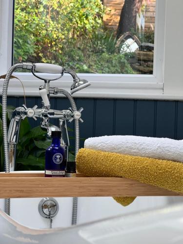 a bottle of soap sitting on top of a bathroom sink at Lewes Beautiful sunny flat in the historic town in Lewes