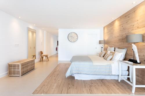 a white bedroom with a bed and a desk at Rooms & Suites Loft 2G Deluxe Edition Arrecife in Arrecife