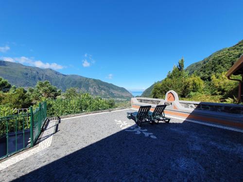 two benches sitting on the side of a road at Mountain-Ocean-View Madeira in São Vicente