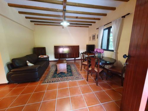 a living room with a couch and a table at Mountain-Ocean-View Madeira in São Vicente