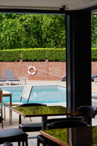 a view of a swimming pool through a window at Talbooth House & Spa in Dedham