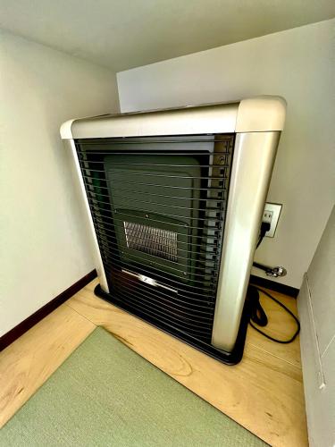 a air heater in a corner of a room at Swiss Inn in Sapporo