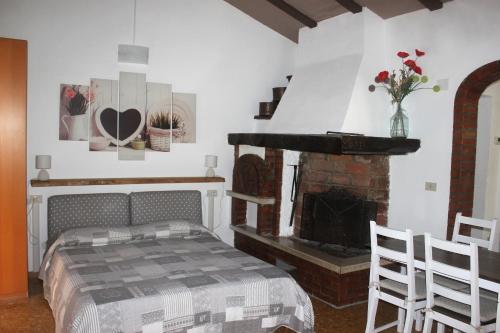 a bedroom with a bed and a fireplace at Fattoria Cristina - Mono in Castelnuovo Magra