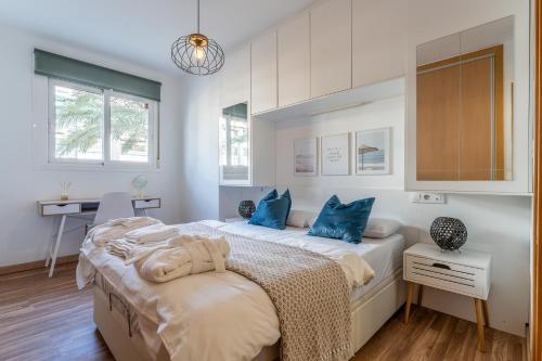 a bedroom with two beds with blue pillows at Spacious 2bed family apartment in Puerto Marina in Benalmádena