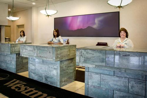 three women sitting at a counter in a room at Westmark Fairbanks Hotel and Conference Center in Fairbanks