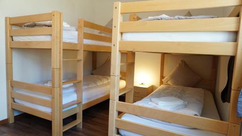 a room with three bunk beds in a room at Ufem Egg Ferienwohnungen in Innertkirchen