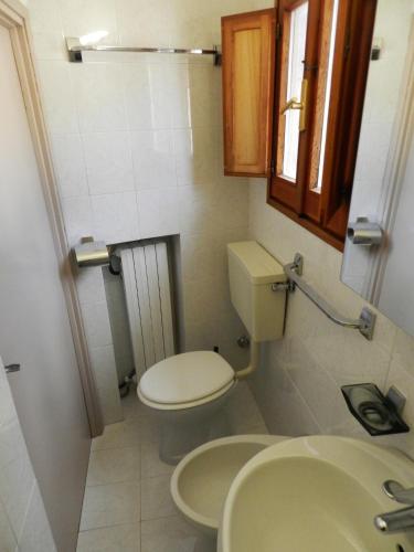 a small bathroom with a toilet and a sink at Casa Nonna Elisa in Scanno