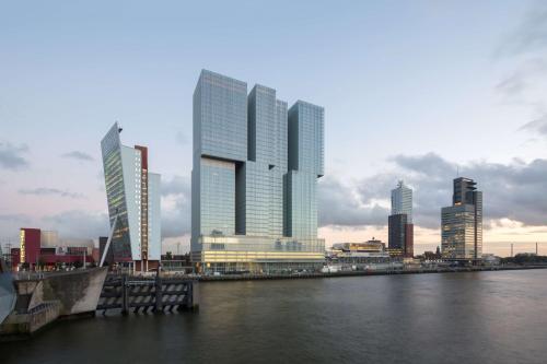 a group of tall buildings in a city next to the water at nhow Rotterdam in Rotterdam