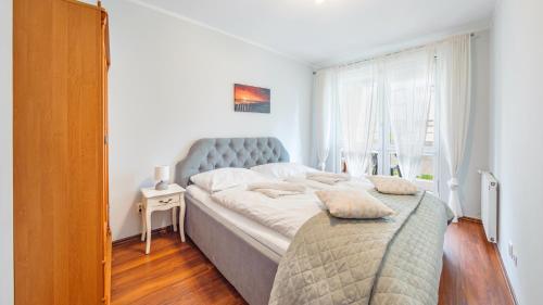 Posteľ alebo postele v izbe v ubytovaní Apartamenty Sun & Snow Kołobrzeg Jantar
