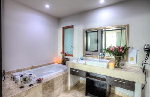a bathroom with a large tub and a sink at Vallarta Shores Beach Hotel in Puerto Vallarta