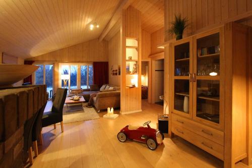 a living room with a small red toy car in it at Ferienhaus Bogense in Steinbergkirche