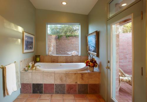 a large bathroom with a tub and a window at Cactus Cove Bed and Breakfast Inn in Tucson
