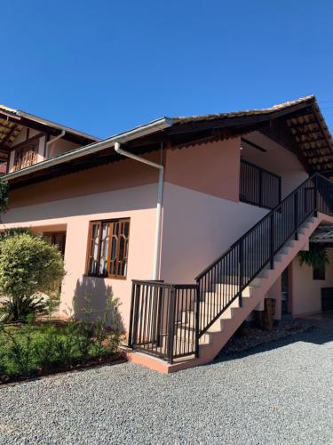 a house with a staircase on the side of it at Casa Aconchego 345 ao lado Alles Park in Pomerode