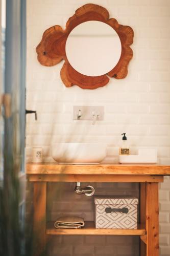 a bathroom sink with a mirror on the wall at Casa da Bia in Conceição