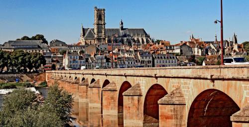 a bridge over a river with a city in the background at Studio tout confort- wifi- Gare-Le Train Bleu 1 in Nevers