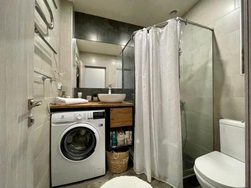 a bathroom with a washing machine and a sink at Kechi Apart 266 in Tsaghkadzor