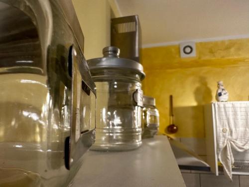 a glass jar sitting on top of a kitchen counter at LA TAVERNA tra gli ulivi in Perinaldo