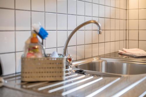 a kitchen sink with a faucet and a sink at Haus zur Vogelweide App 3 in Dobbiaco