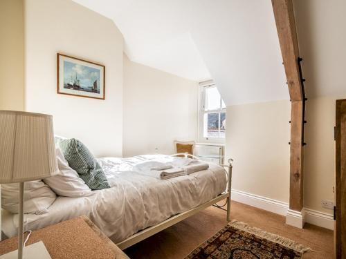 a bedroom with a bed and a window at Pass the Keys Meldon View Period Dartmoor apartment with large roof terrace in Newton Abbot