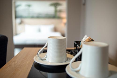 two stacks of white plates sitting on a table at Radisson Serviced Apartments Antananarivo City Centre in Antananarivo