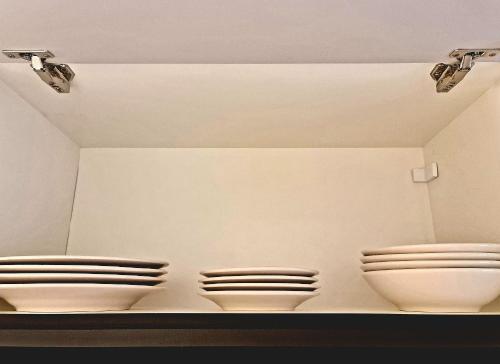 two toilets in a room with lights on the ceiling at Seasons BC in Cabeçudas