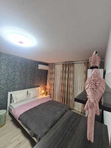 a bedroom with a large bed with pink sheets at Ghencea Residence 158 Floor 10 in Bucharest