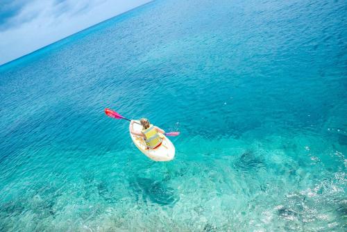 a person in a kayak in the water at Miraflores Boutique Hotel Adults Only in San Andrés