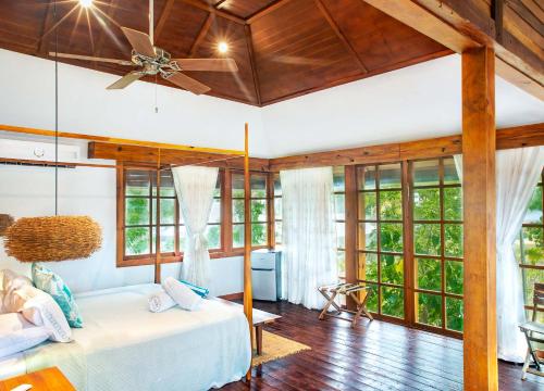 a bedroom with a bed and a ceiling fan at Miraflores Boutique Hotel Adults Only in San Andrés