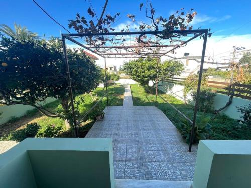 a walkway leading to a garden with trees at The Chill Casa in Kokkíni Khánion