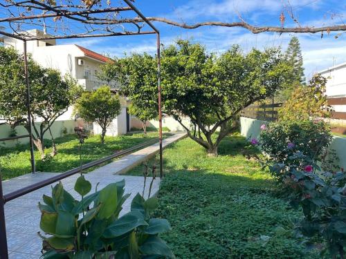 a garden with a swing in a yard at The Chill Casa in Kokkini Khanion