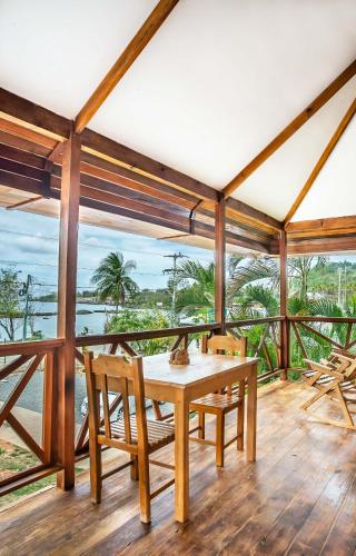 a dining room with a table and chairs and the ocean at Miraflores Boutique Hotel Adults Only in San Andrés