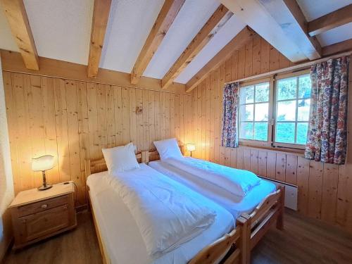 a bedroom with two beds and a window at Apartment Pinot Gris combles by Interhome in Verbier