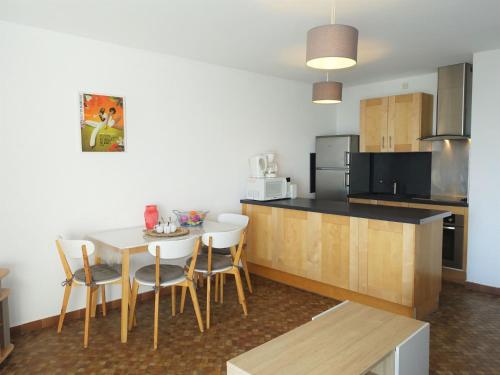 een keuken met een tafel en stoelen in een kamer bij Apartment Maisons sur la Plage-1 by Interhome in Gruissan