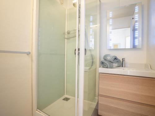 a glass shower in a bathroom with a sink at Apartment Armoise 32 by Interhome in Les Menuires
