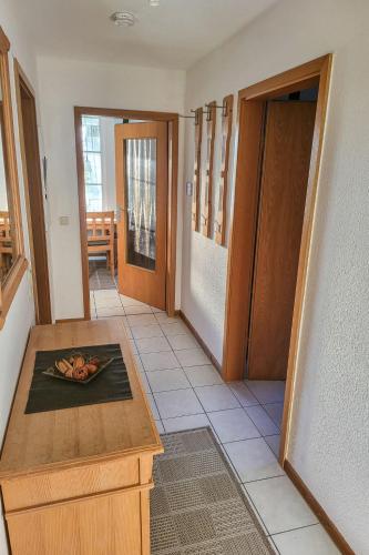 a hallway with a room with a table and a door at Apartment im Dörp-1 by Interhome in Waase