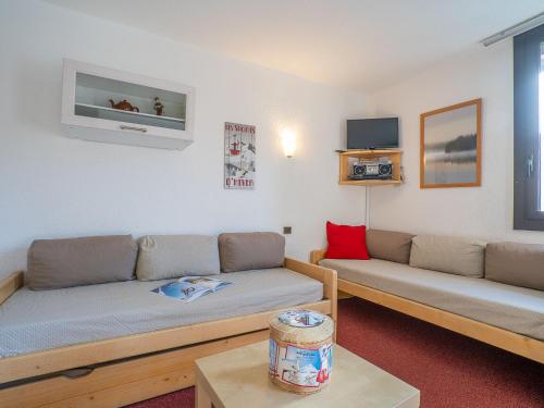 a living room with two couches and a table at Apartment Armoise 32 by Interhome in Les Menuires