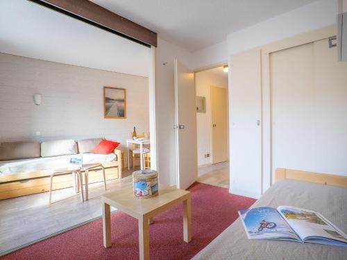 a room with a bed and a table and a couch at Apartment Armoise 32 by Interhome in Les Menuires
