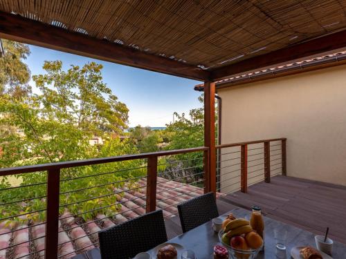 a table with fruit on a balcony with a view at Apartment Residence Marina di Favone- T2- 2-4 pers-1 by Interhome in Favone