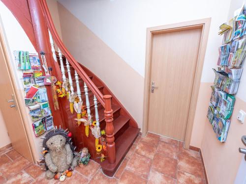 a staircase with a stuffed animal sitting on the floor at Apartment An der Eine-1 by Interhome in Stangerode