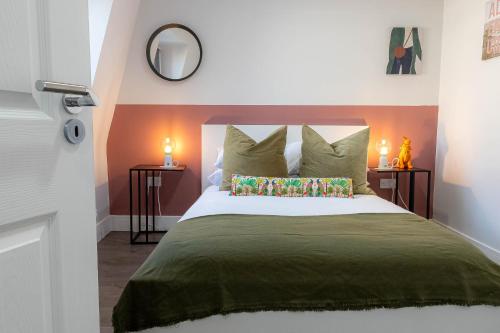 a bedroom with a large bed with two lamps at Camden Apartments Next to Market and Tube Station in London
