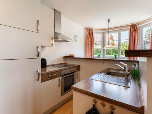 a kitchen with a sink and a refrigerator at Apartment Top 4 by Interhome in Sankt Margarethen im Lungau