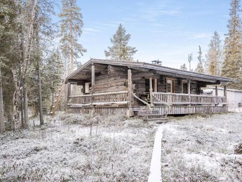 eine Blockhütte im Wald mit Schnee auf dem Boden in der Unterkunft Holiday Home Pajalan honka by Interhome in Kuusamo